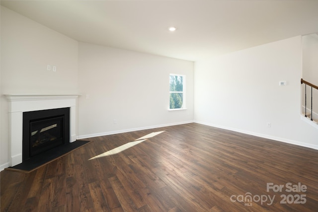 unfurnished living room with dark wood-type flooring