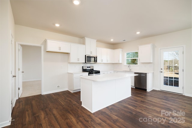 kitchen featuring a kitchen island, white cabinets, and appliances with stainless steel finishes