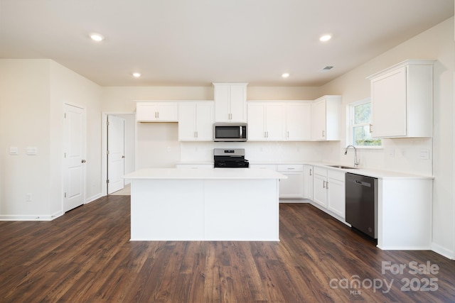 kitchen featuring sink, white cabinets, a center island, and stainless steel appliances