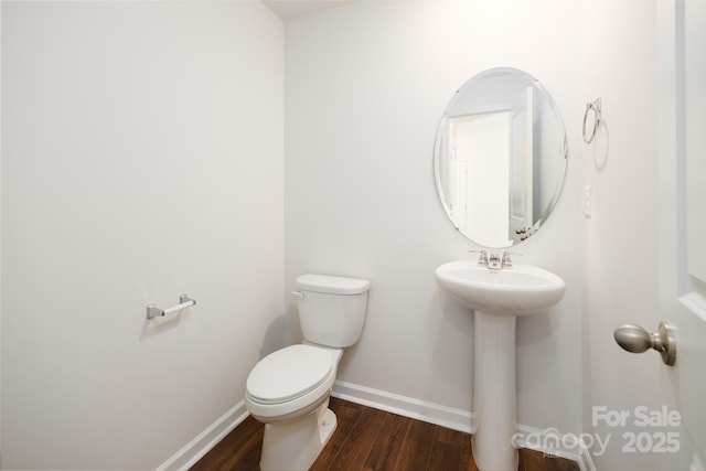 bathroom with sink, wood-type flooring, and toilet