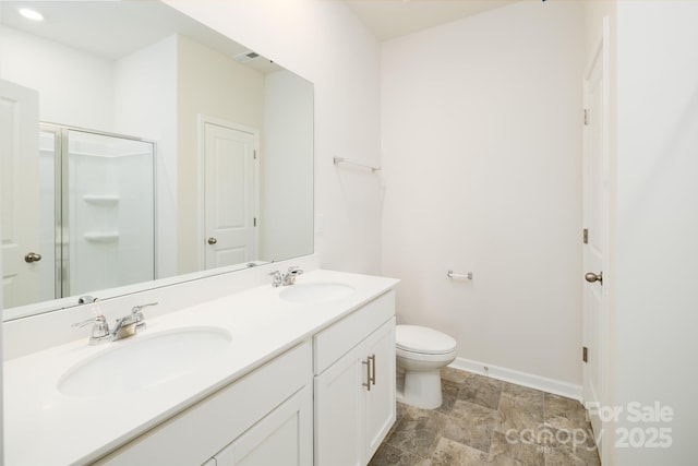 bathroom featuring walk in shower, vanity, and toilet