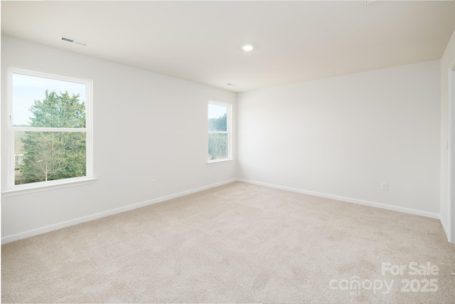 empty room with light colored carpet