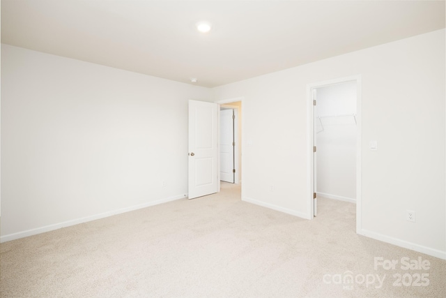 unfurnished room featuring light colored carpet