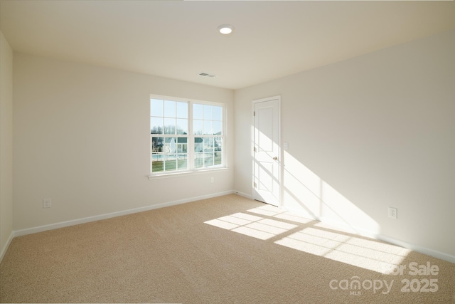 unfurnished room with light carpet