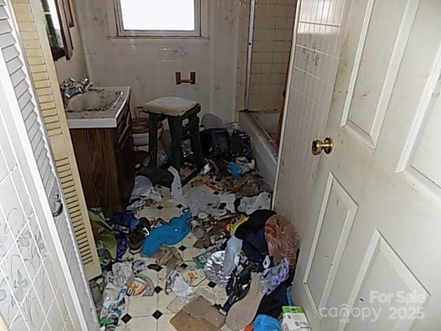 bathroom with vanity and tiled shower