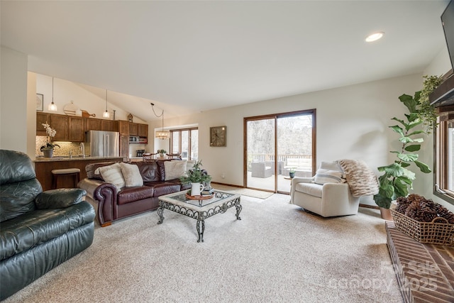 living room featuring vaulted ceiling and light carpet