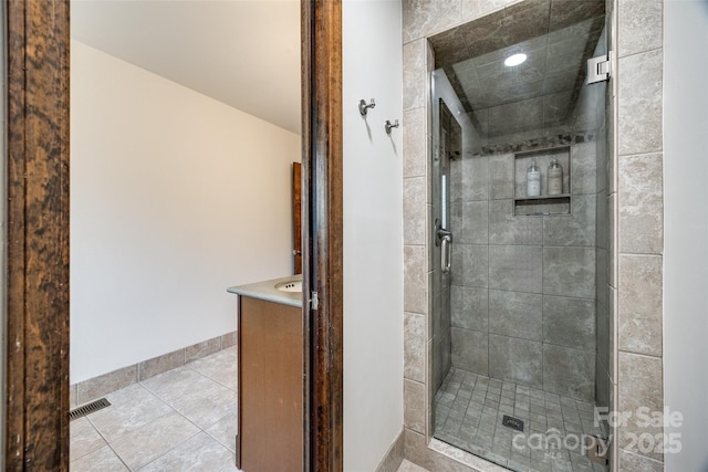 bathroom featuring an enclosed shower, tile patterned floors, and vanity