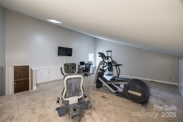 exercise area with light colored carpet and lofted ceiling