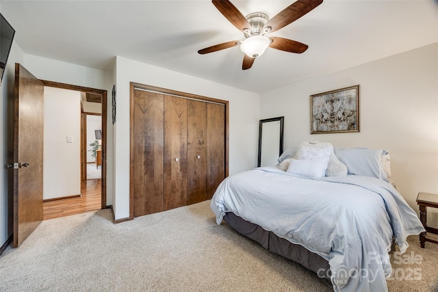 bedroom featuring light carpet, a closet, and ceiling fan