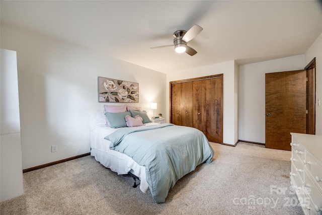 carpeted bedroom featuring ceiling fan and a closet