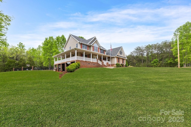 view of front of home with a sunroom, covered porch, and a front yard