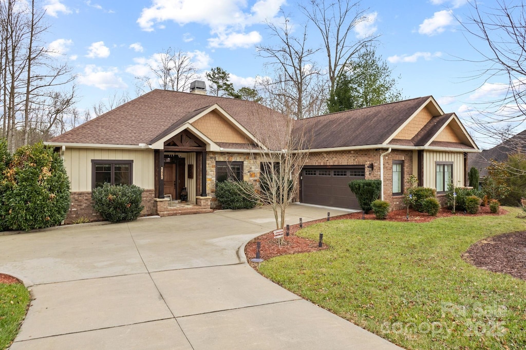 craftsman-style house featuring a front yard and a garage