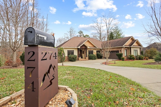 view of front of property with a front lawn and a garage