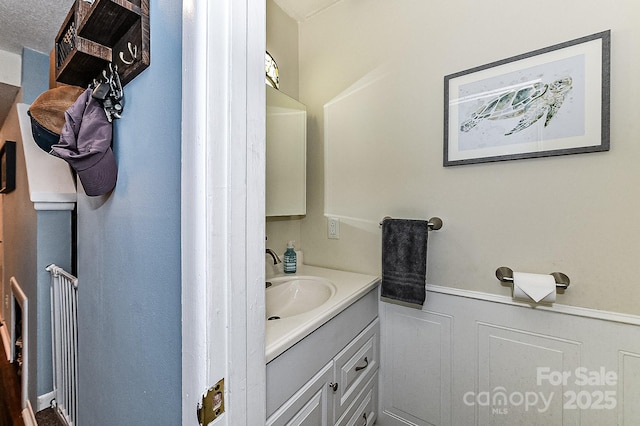 bathroom featuring a textured ceiling and vanity