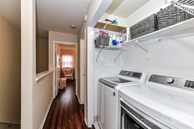 laundry area with a textured ceiling, separate washer and dryer, and dark hardwood / wood-style floors