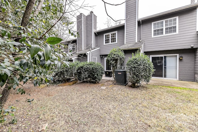 rear view of property with central air condition unit