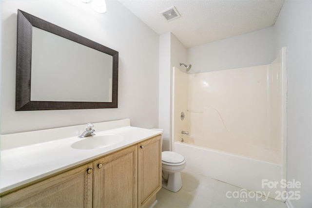 full bath featuring visible vents, shower / washtub combination, toilet, vanity, and a textured ceiling