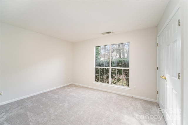 unfurnished bedroom with visible vents, carpet, and baseboards