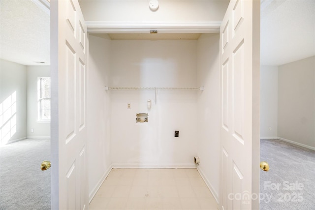 clothes washing area featuring baseboards, light carpet, washer hookup, and laundry area