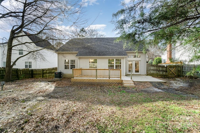 back of house featuring french doors, a wooden deck, central AC unit, and a fenced backyard