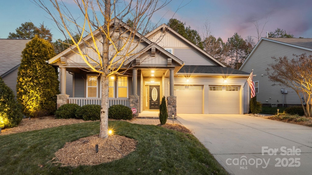 craftsman-style house featuring a porch and a garage