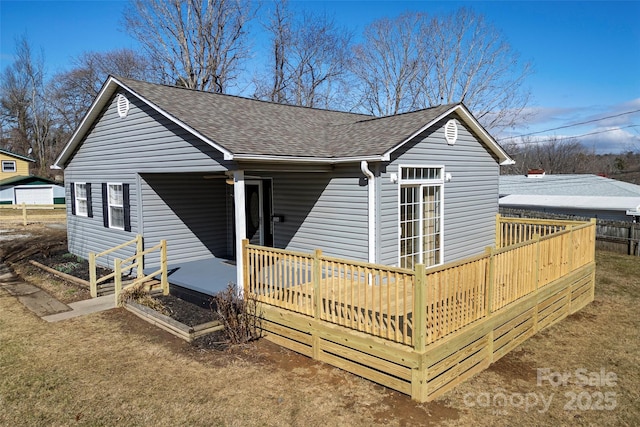 rear view of house featuring a deck