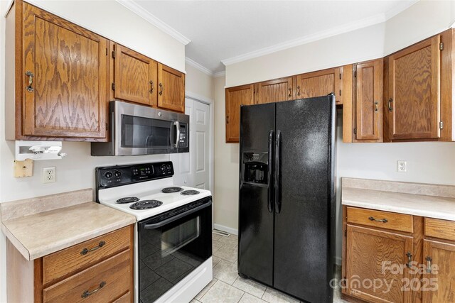 kitchen featuring ornamental molding, electric range oven, light tile patterned floors, and black fridge with ice dispenser