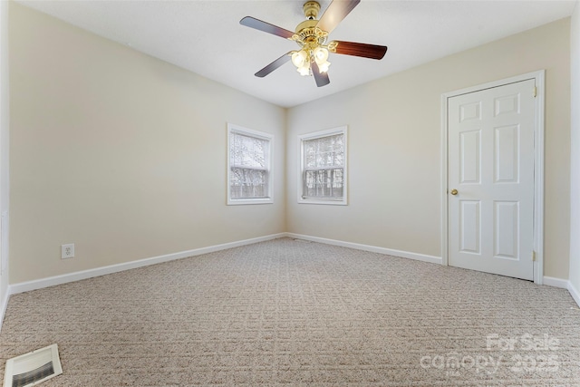 empty room with ceiling fan and carpet