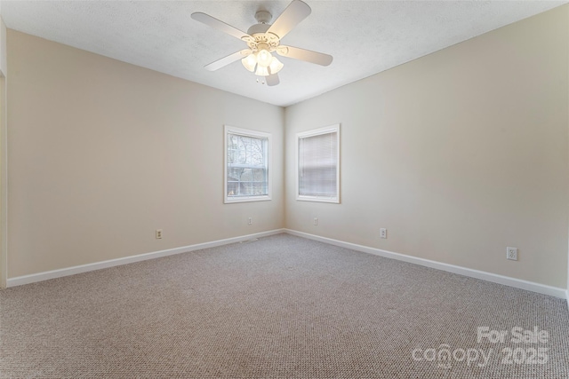 carpeted empty room featuring a textured ceiling and ceiling fan