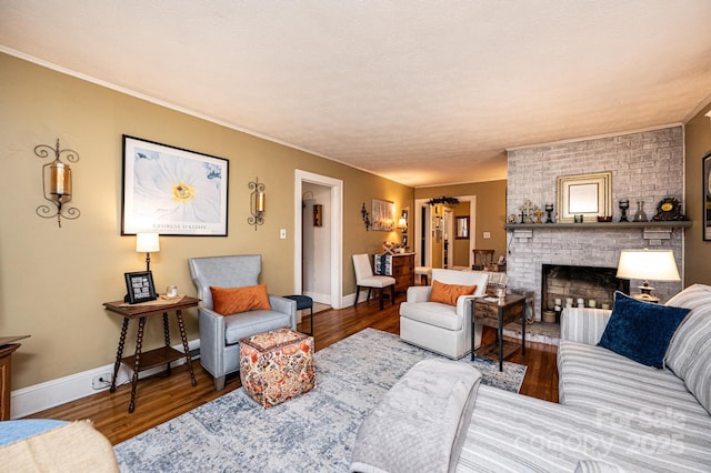 living room with a brick fireplace and hardwood / wood-style flooring