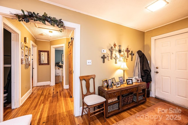 foyer featuring ornamental molding and hardwood / wood-style floors