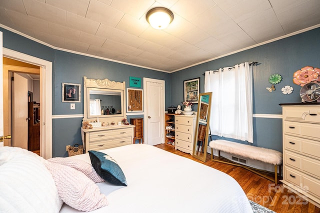 bedroom with dark wood-type flooring and ornamental molding