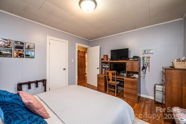 bedroom with crown molding and hardwood / wood-style flooring