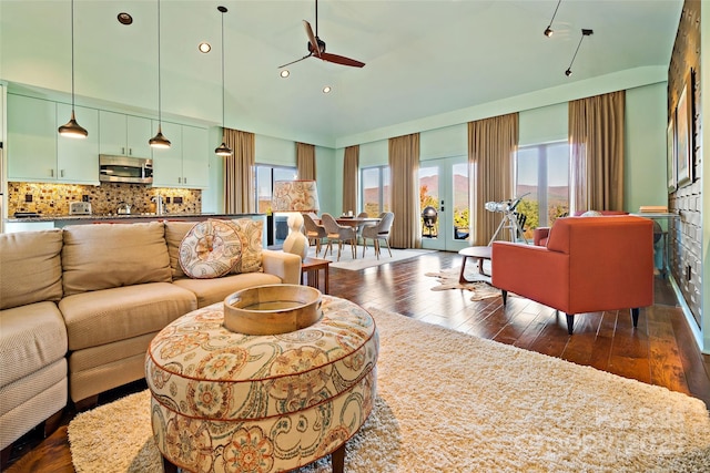 living room with ceiling fan and dark hardwood / wood-style floors