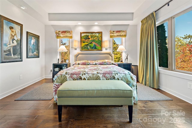 bedroom with dark wood-type flooring and multiple windows