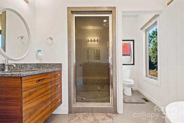 bathroom with tile patterned floors, walk in shower, toilet, and vanity