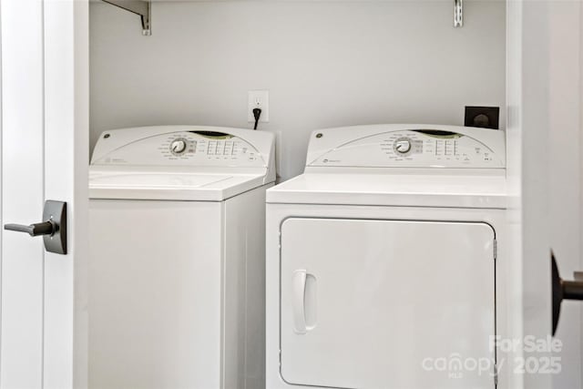 washroom featuring washer and clothes dryer