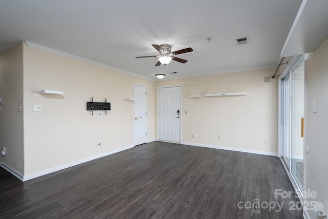 empty room with crown molding, dark wood-type flooring, and ceiling fan