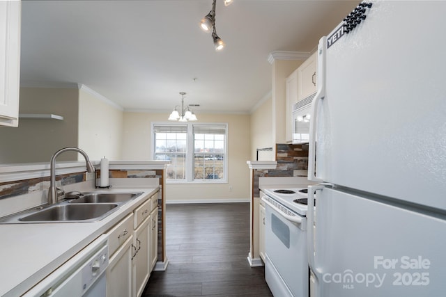 kitchen with pendant lighting, sink, white appliances, and white cabinets