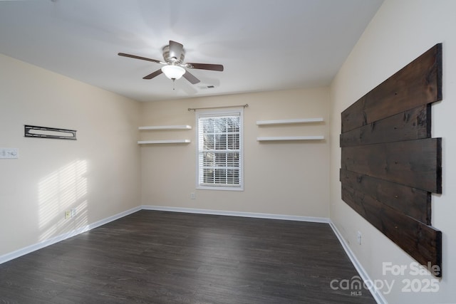 empty room featuring ceiling fan and dark hardwood / wood-style flooring