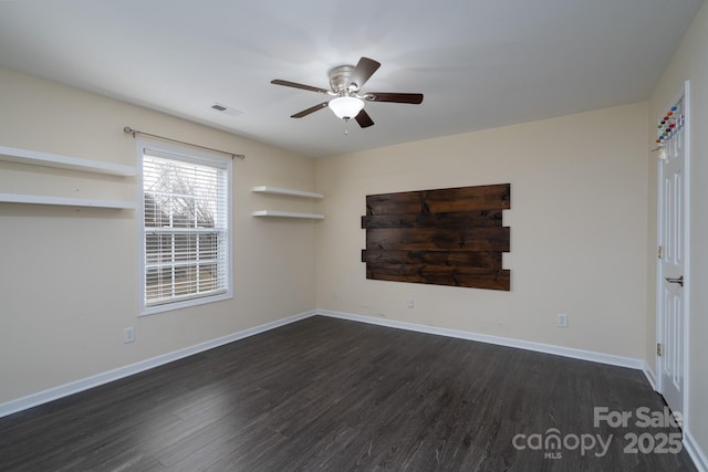 unfurnished room featuring dark wood-type flooring and ceiling fan