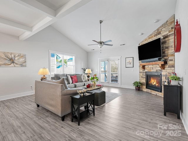 living room with a wealth of natural light, hardwood / wood-style floors, ceiling fan, and a fireplace