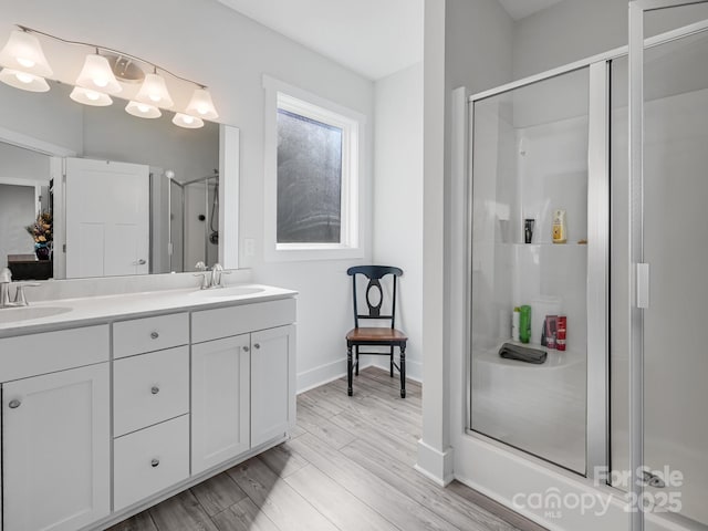 bathroom with vanity, hardwood / wood-style floors, and walk in shower