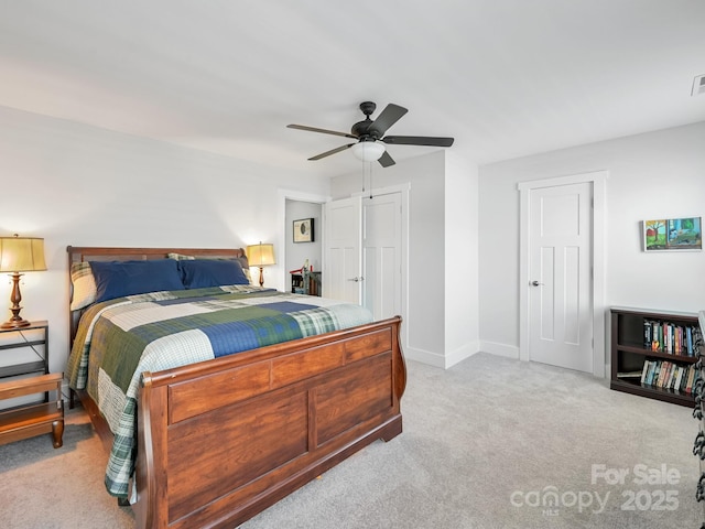 bedroom featuring light colored carpet and ceiling fan