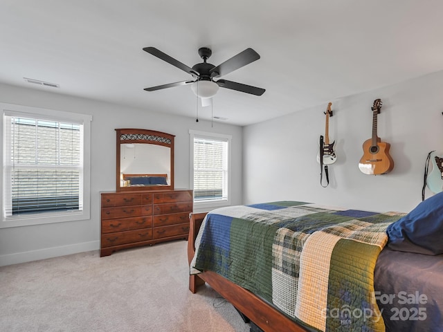 bedroom featuring light carpet and ceiling fan