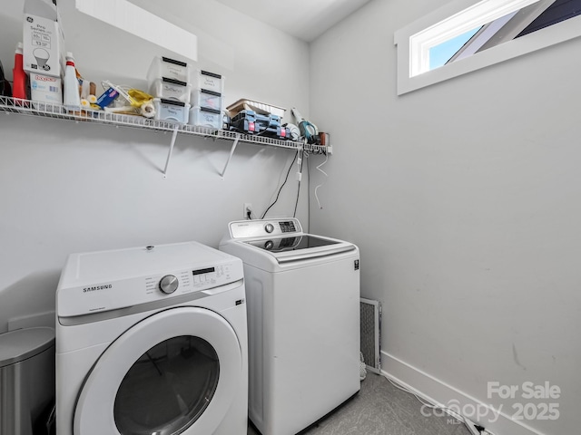 washroom with washer and dryer