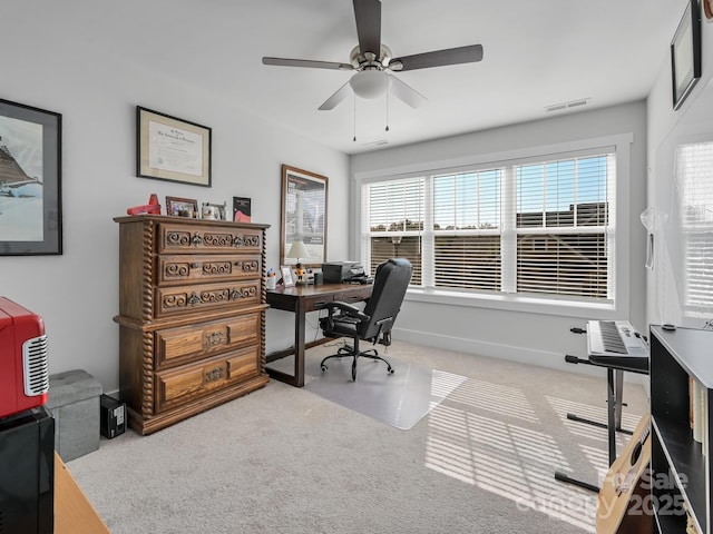 carpeted home office featuring a healthy amount of sunlight and ceiling fan