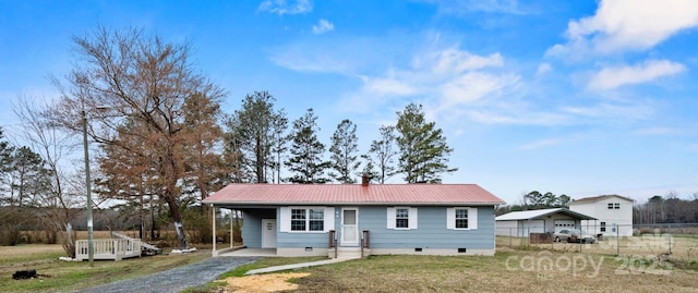 ranch-style house featuring metal roof, fence, driveway, crawl space, and a front yard