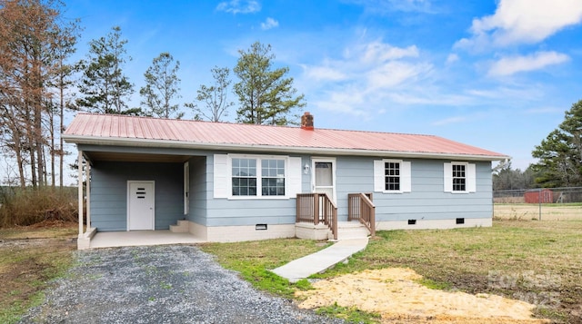 single story home with metal roof, fence, crawl space, a carport, and gravel driveway