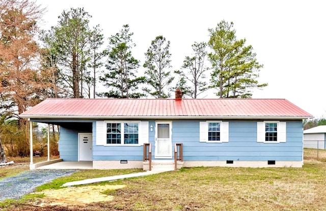 ranch-style house with gravel driveway, a chimney, a front yard, crawl space, and metal roof